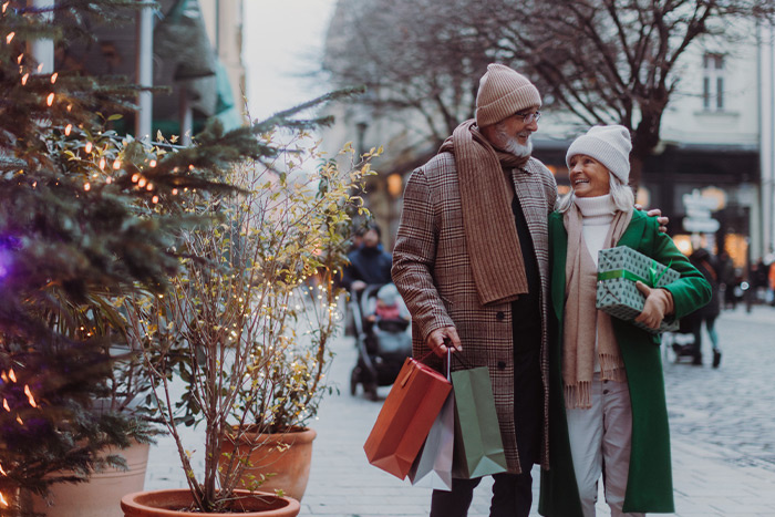Elderly couple happily shopping for holidays